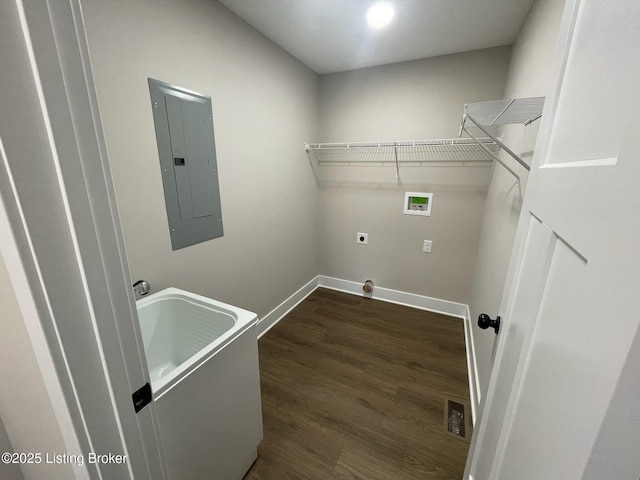 washroom with washer hookup, dark wood-type flooring, laundry area, electric panel, and baseboards