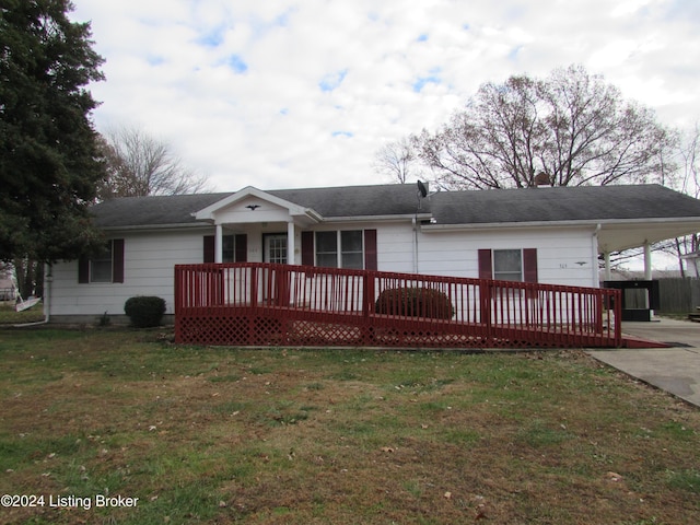 back of property with a lawn, a carport, and a deck