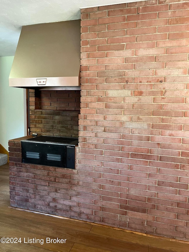 interior details featuring hardwood / wood-style flooring and range hood