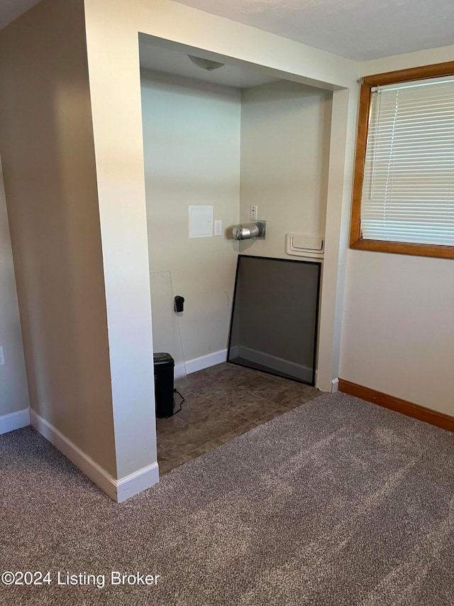 clothes washing area with carpet floors