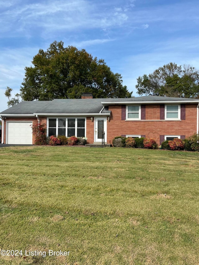 view of front of property featuring a garage and a front lawn