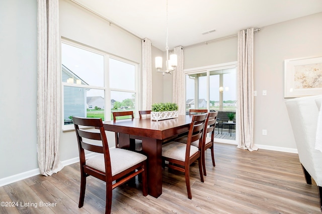 dining area with an inviting chandelier and wood-type flooring