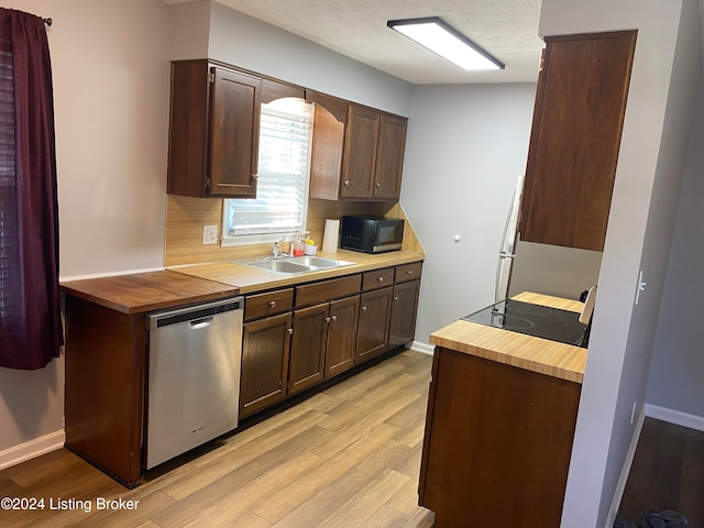 kitchen featuring dark brown cabinetry, light hardwood / wood-style floors, black appliances, and sink