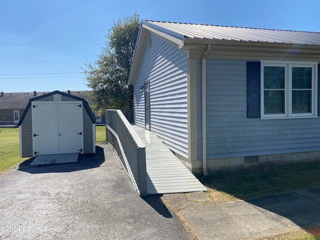 view of home's exterior with a storage unit