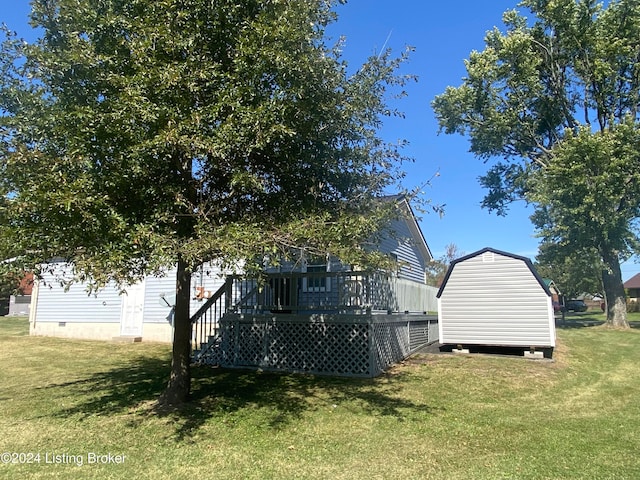 view of yard featuring a storage shed and a deck