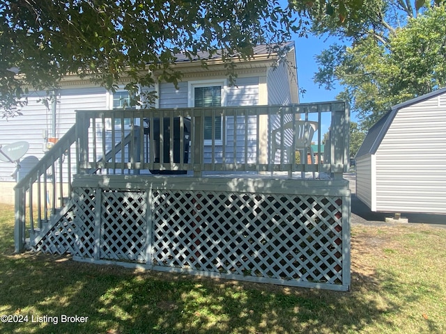 back of property with a yard and a deck
