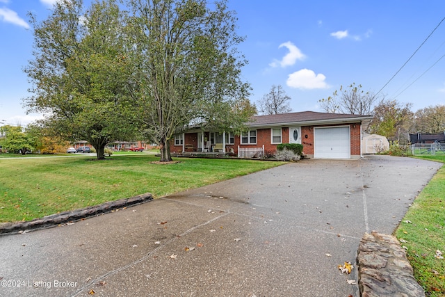 single story home with a garage and a front lawn