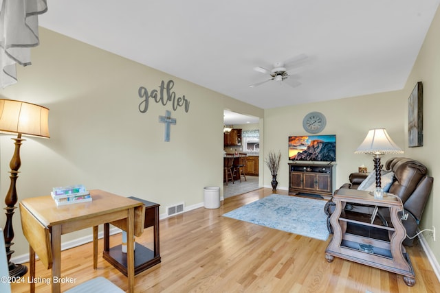 living room with ceiling fan and hardwood / wood-style floors