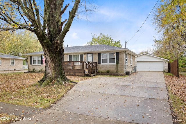 view of front of home with a garage and an outbuilding