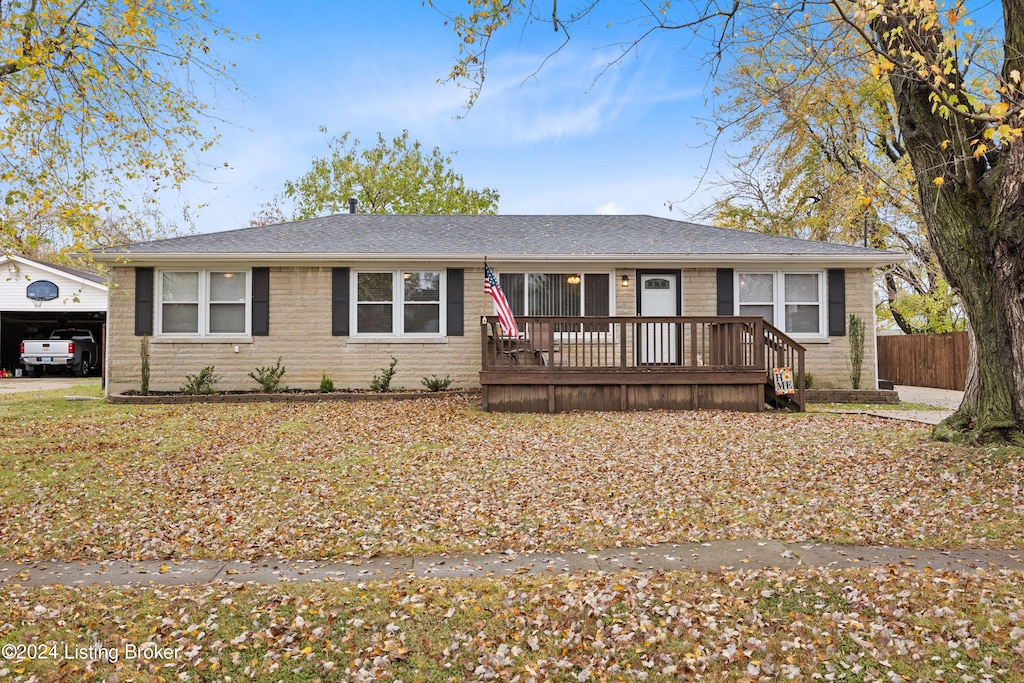 single story home with a wooden deck