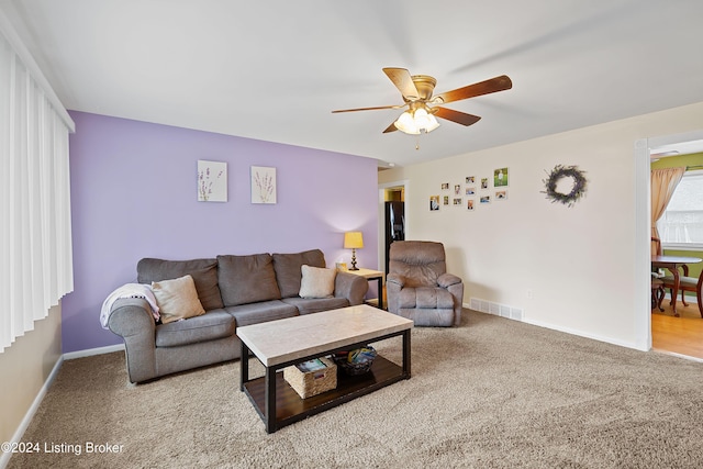 living room featuring ceiling fan and carpet