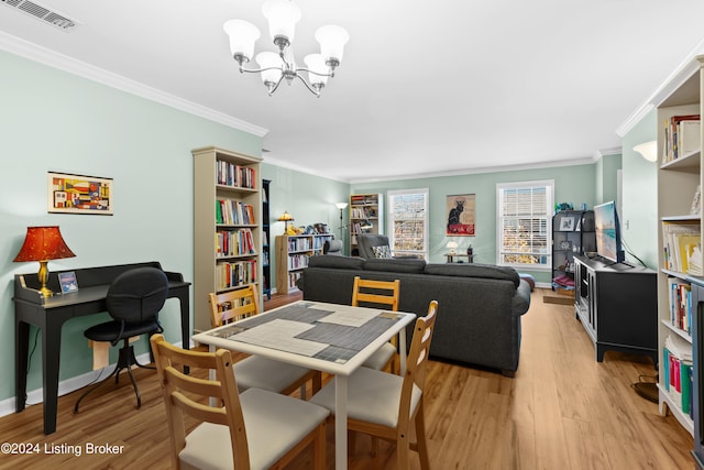 dining room with a notable chandelier, crown molding, and light hardwood / wood-style floors