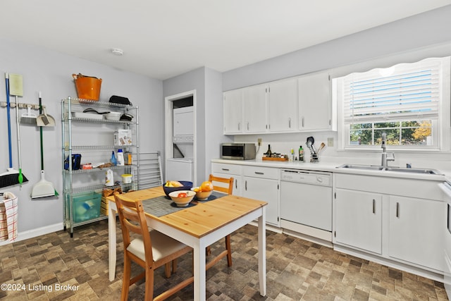 kitchen with white cabinets, dishwasher, and sink