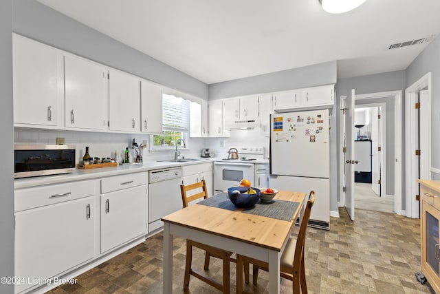 kitchen with backsplash, sink, white cabinets, and white appliances