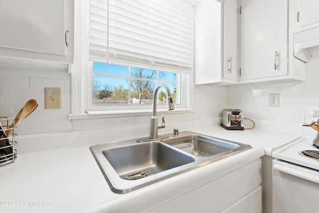 kitchen with white cabinetry, sink, ventilation hood, backsplash, and white range with electric cooktop