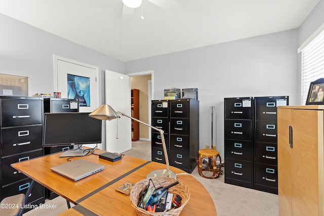 carpeted office space with ceiling fan