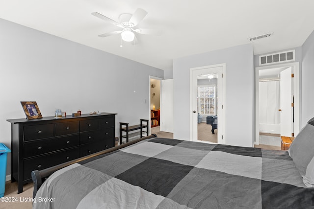 carpeted bedroom featuring ensuite bath and ceiling fan