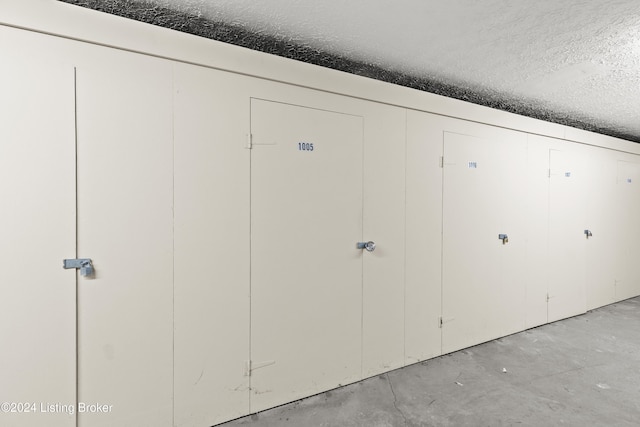 interior space featuring concrete floors and a textured ceiling