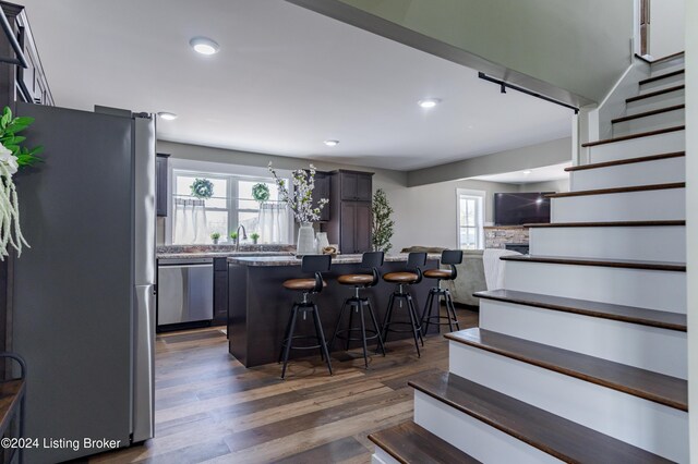 216 Millerstown St, Clarkson, KY 42726 - kitchen with stainless steel appliances, a breakfast bar area, dark wood-style flooring, a kitchen island, and recessed lighting