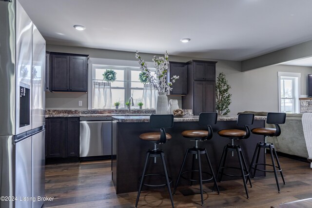 216 Millerstown St, Clarkson, KY 42726 - kitchen featuring stainless steel appliances, a kitchen island, a kitchen bar, dark wood-style floors, and recessed lighting