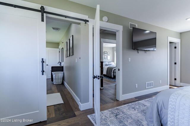 216 Millerstown St, Clarkson, KY 42726 - bedroom featuring wood finished floors, baseboards, and a barn door