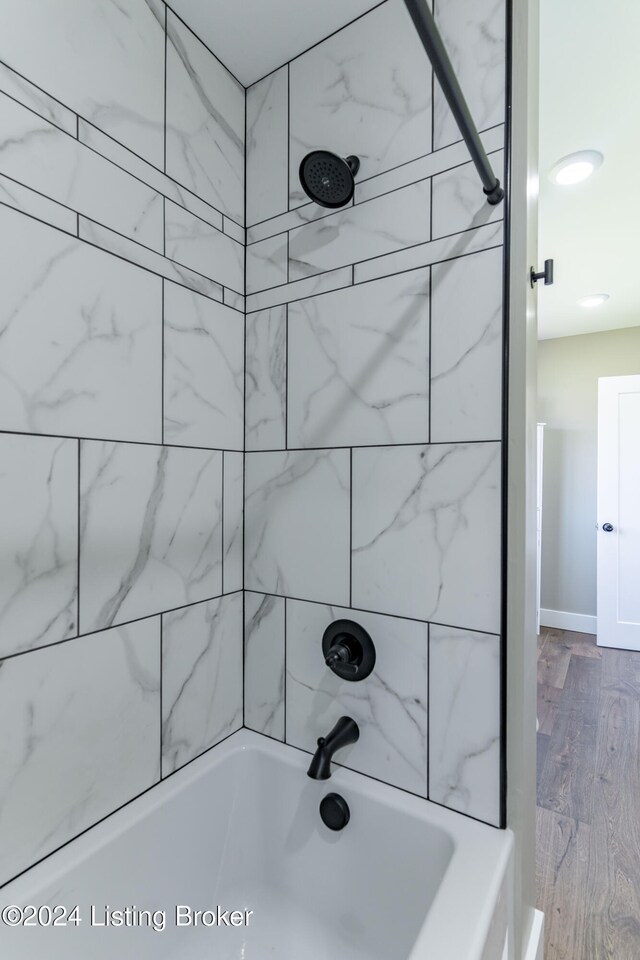 216 Millerstown St, Clarkson, KY 42726 - bathroom with shower / washtub combination and wood finished floors