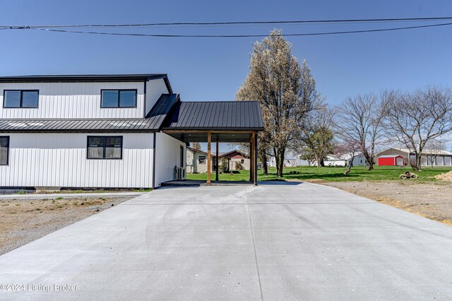 216 Millerstown St, Clarkson, KY 42726 - view of front of house with metal roof, concrete driveway, and a standing seam roof