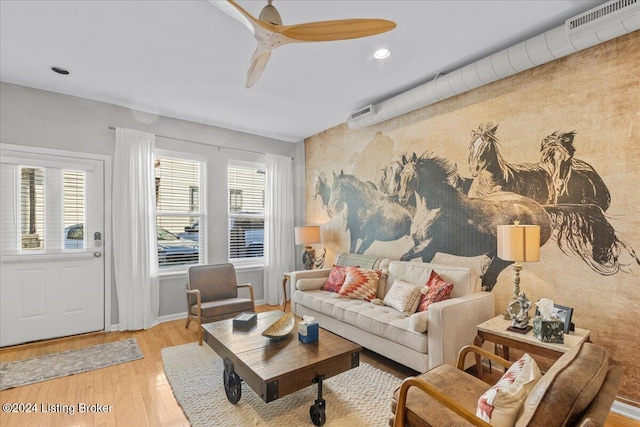 living room with light hardwood / wood-style flooring and ceiling fan