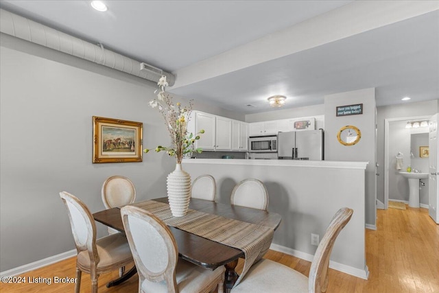 dining space with light hardwood / wood-style floors