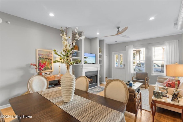 dining space featuring light hardwood / wood-style floors and ceiling fan