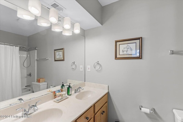 full bathroom featuring toilet, shower / tub combo with curtain, and vanity