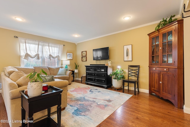 living room featuring hardwood / wood-style flooring and crown molding