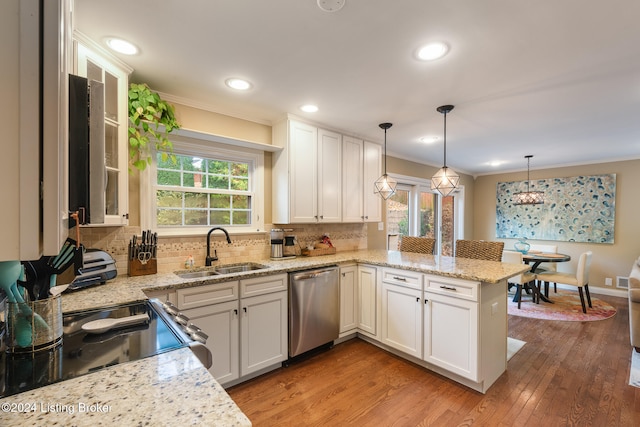 kitchen with white cabinets, appliances with stainless steel finishes, hanging light fixtures, and sink