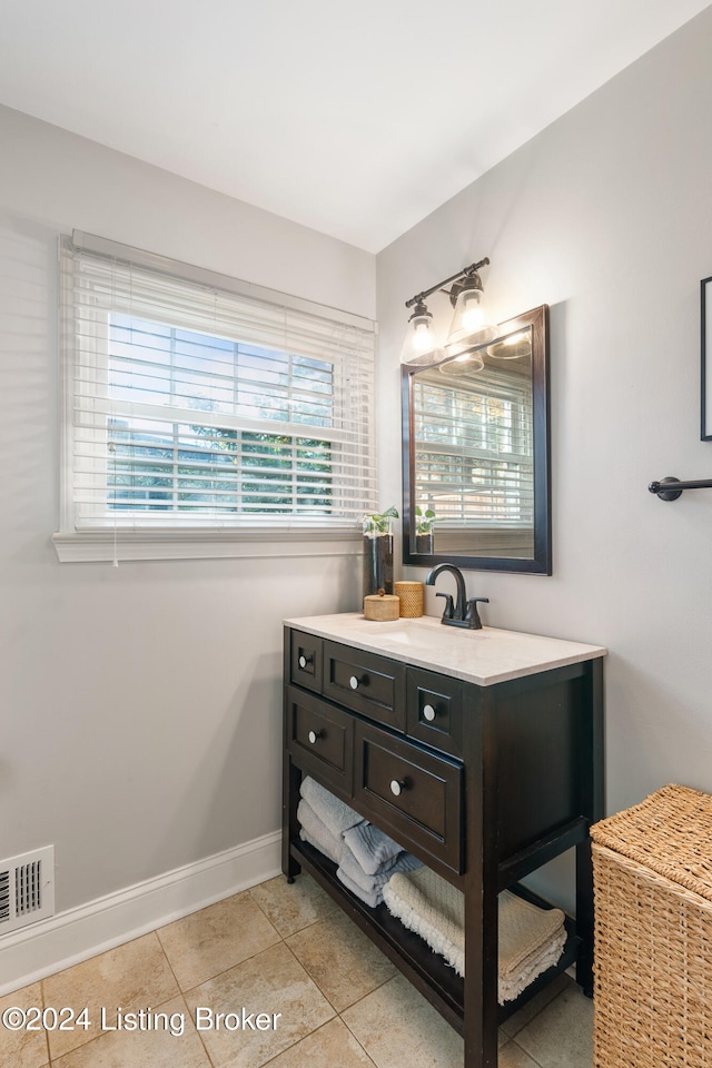 bathroom with tile patterned flooring and vanity