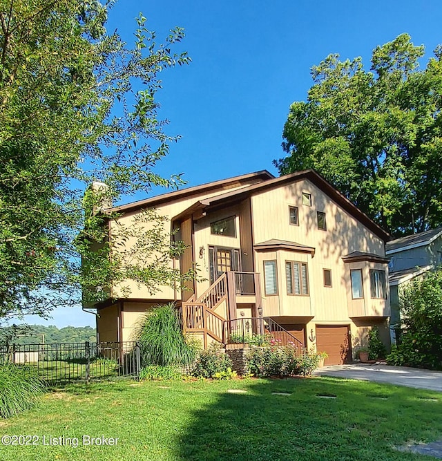 bi-level home with a front lawn and a garage