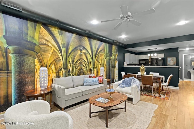 living room with ceiling fan and light wood-type flooring