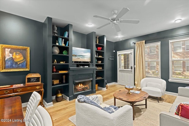 living room featuring ceiling fan and light hardwood / wood-style floors