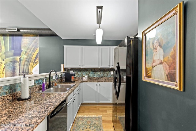 kitchen featuring light hardwood / wood-style floors, sink, decorative light fixtures, white cabinets, and dishwasher