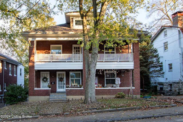 view of front of house with a porch and a balcony