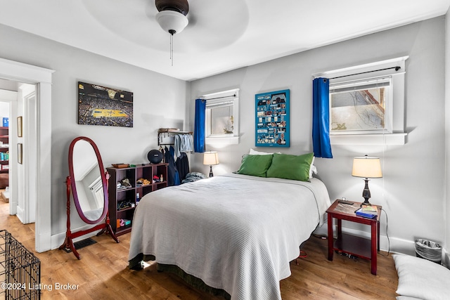 bedroom with ceiling fan and wood-type flooring