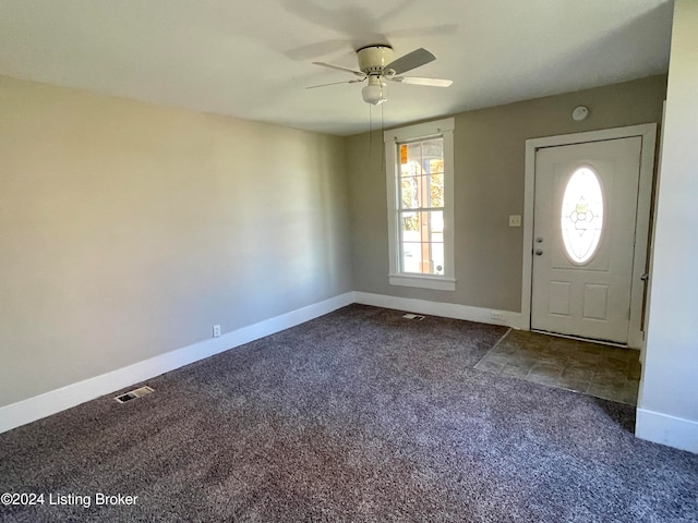 foyer featuring carpet flooring and ceiling fan