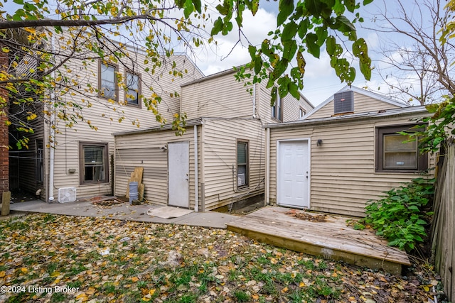 rear view of house featuring a deck and a patio