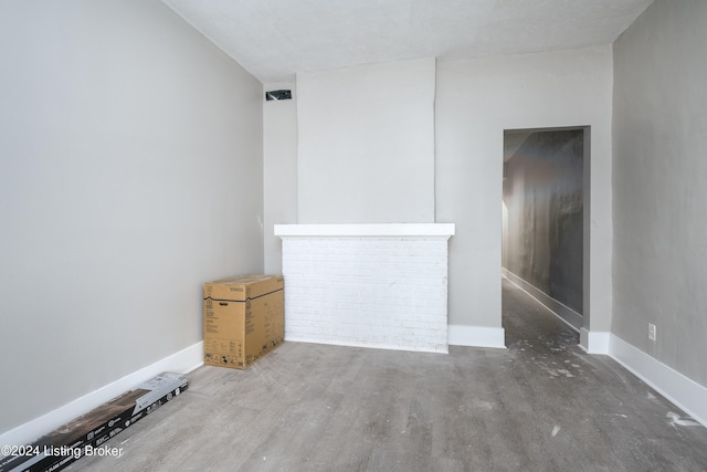 unfurnished room featuring wood-type flooring and a textured ceiling