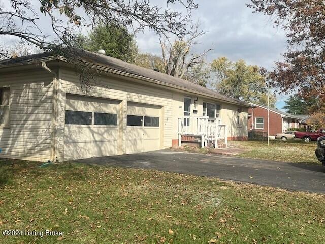 view of home's exterior featuring a garage and a yard