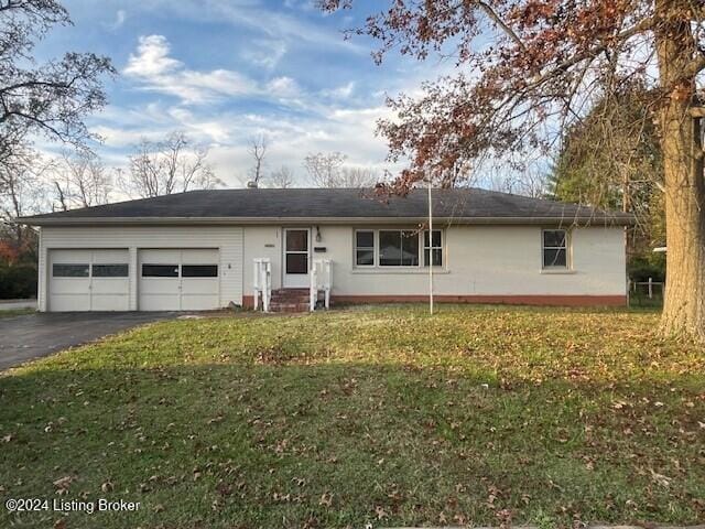 ranch-style home with a garage and a front lawn