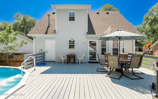 back of property featuring a swimming pool side deck