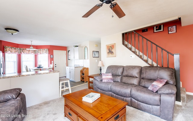 living room featuring light carpet and ceiling fan