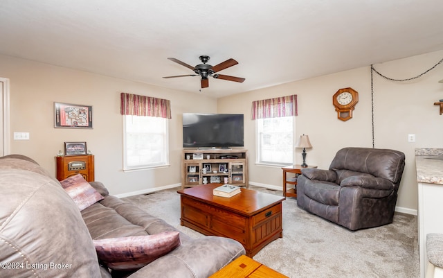 living room with a wealth of natural light, light colored carpet, and ceiling fan