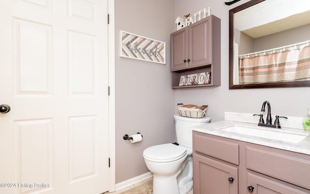 bathroom featuring toilet and vanity