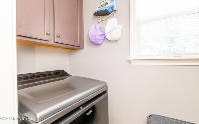 laundry room with washer / dryer and cabinets